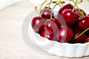 Cherries in white bowl. Cherry on white background. - healthy eating and food concept