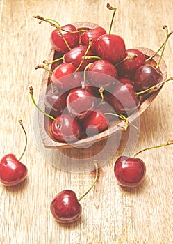 Cherries on wooden board.