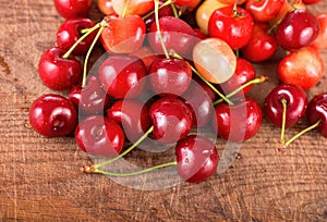 Cherries on wooden table with water drops