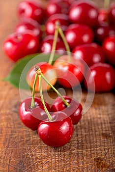 Cherries on wooden table with water drops