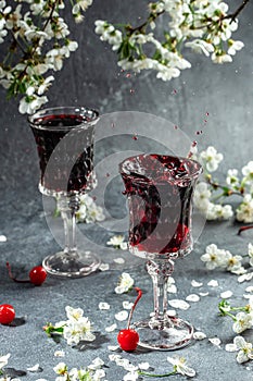 cherry alcoholic drink in a glass and fresh fruit, vertical image. top view. place for text