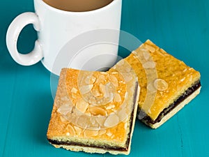 Cherry Bakewell Tarts With a Cup or Mug of Tea or Coffee