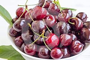 Cherry berries in a bowl on a white background. Fresh cherries. The concept of a healthy diet and support for local producers. Clo