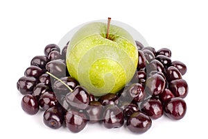 Cherry berries and one big green apple on white background isolated close up macro