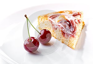 Cherry berries and piece of cream fruit pie on white plate close-up