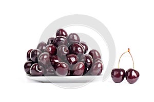 Cherry berries in water drops on white plate white background isolated close up macro