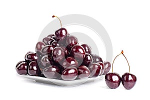 Cherry berries in water drops on white plate white background isolated close up macro