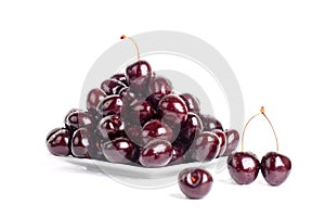 Cherry berries in water drops on white plate white background isolated close up macro