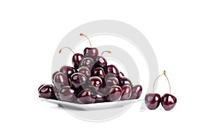 Cherry berries in water drops on white plate white background isolated close up macro