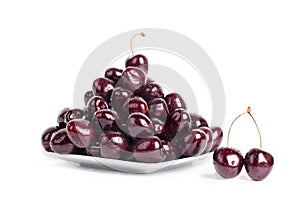 Cherry berries in water drops on white plate white background isolated close up macro