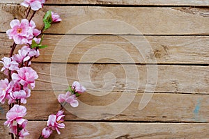 Cherry blossom and Artificial flowers on vintage wooden background with copy space