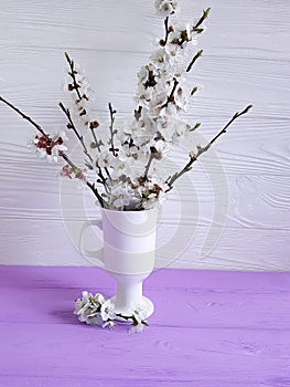 Cherry blossom branch natural vintage beautiful in a vase on a colored wooden background, spring,