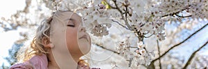 Cherry blossoms. The girl enjoys the scent of Japanese cherry blossoms. Cherry blossom in japan in spring.