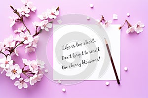 Cherry Blossoms On Purrple Background. Inspirational Message About Life On White Paper.