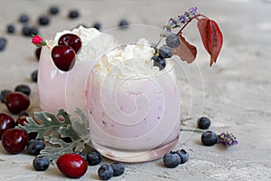 Cherry, blueberry, apricot smoothie on light background. well being and weight loos concept. milkshake with fresh berries. healthy photo