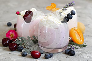 Cherry, blueberry, apricot smoothie on light background. well being and weight loos concept. milkshake with fresh berries. healthy photo
