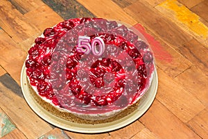 Cherry cheese cake with candles for 50th birthday