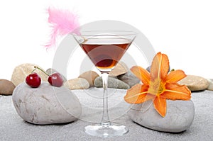 Cherry cocktail in a environment of sand and pebble stones