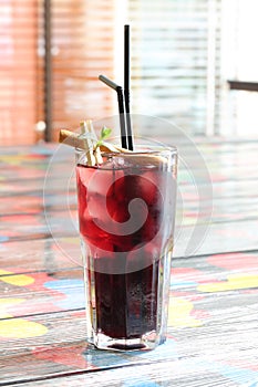 Cherry cocktail with mint, cinnamon and ice