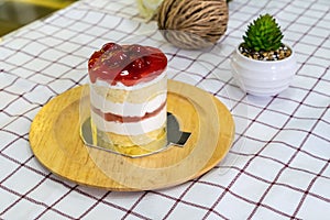 Cherry Cream Cake on wooden plate and coffee cup
