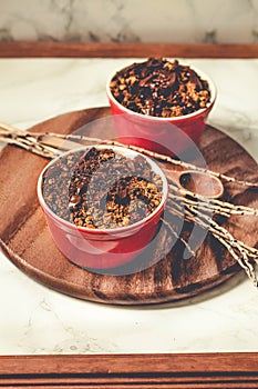 Cherry crumble with chocolate granola served served in portioned red cups.Toning