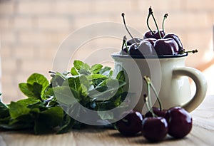 Cherry in cup on wooden table