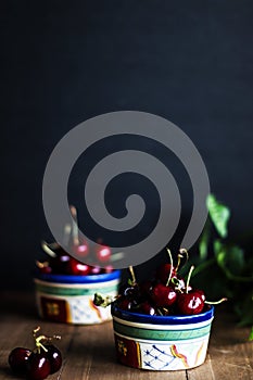 cherry on a dark background in a bowl