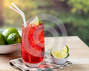 Cherry drink with lime slice and ice