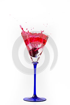 Cherry drop into red wine with splash