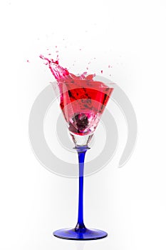 Cherry drop into red wine with splash