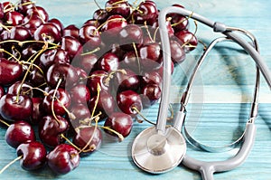 cherry folded in the shape of a heart and a stethoscope in blue background