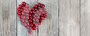 Cherry heart shape on a wooden rustic background