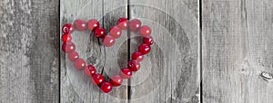 Cherry heart shape on a wooden rustic background