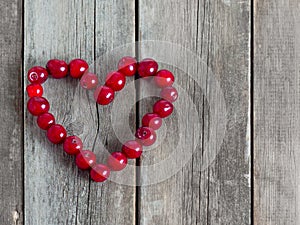 Cherry heart shape on a wooden rustic background