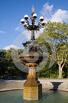 Cherry Hill fountain with trees blue sky in summer at Central Park