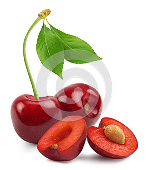 Cherry isolated. Sweet cherries and cherry slices with leaf isolated on white background. Fresh fruit berries.