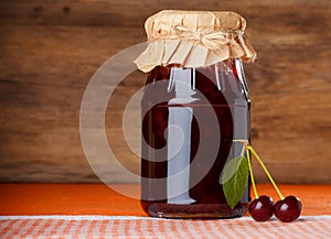 Cherry jam jar on dishcloth photo