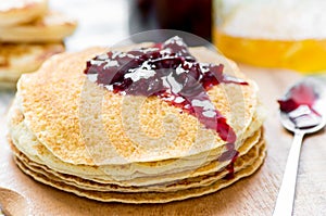 Cherry jam on a stack of pancakes Russian blini