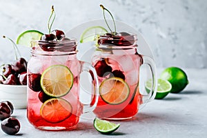 Cherry Limeade or Lemonade in glass mason jar. Ice cold summer drink.