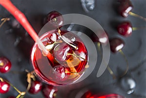 Cherry, limonada glass of cherry on a black background, berries photo