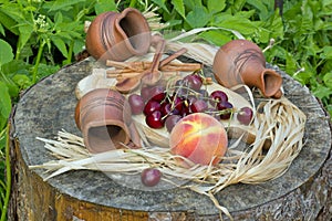 cherry and peach on a wooden stump