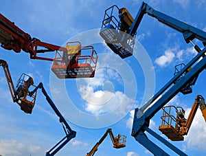 A group of cherry pickers, aerial work platforms, seen from below photo