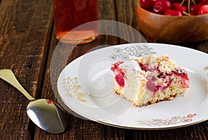 Cherry pie on white plate placed on wooden board