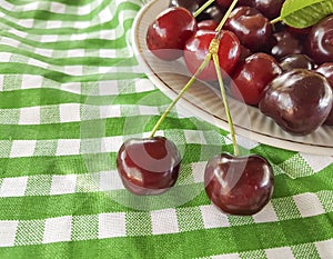 Cherry in a plate organic tasty vitamin summer on a background, towel
