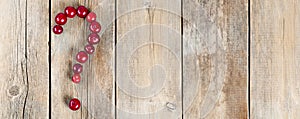 Cherry question symbol on a wooden rustic background