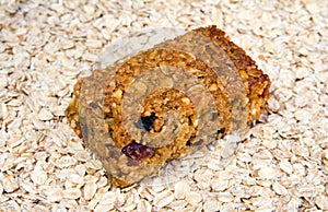 Cherry and raisin flapjack on an oat background photo