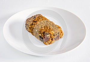 Cherry and raisin flapjack on a white plate