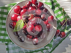 cherry raw in a plate delicious on a white wooden