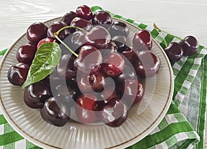 cherry raw in a plate summer delicious on a white wooden