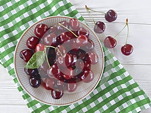 cherry raw in a plate summer organic delicious ripe on a white wooden
